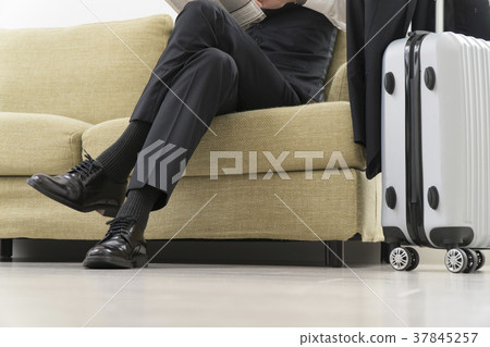 Businessman reading a newspaper on the couch 37845257