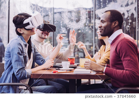Charming two friends wearing VR headset 37845660