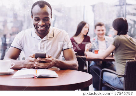 Adorable male student typing while cramming 37845797