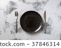 Black Plate on white wooden background  37846314
