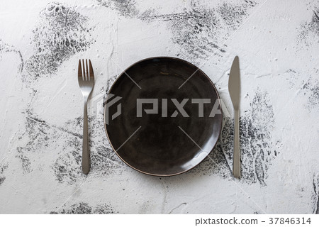 Black Plate on white wooden background  37846314