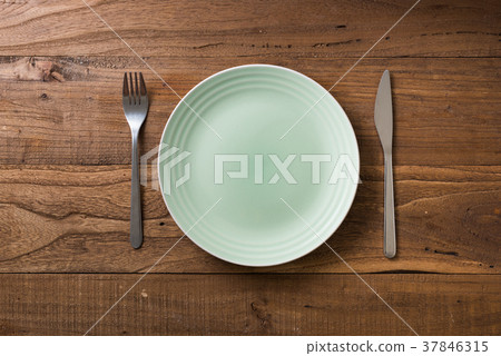 Green Plate on brown wooden background  37846315