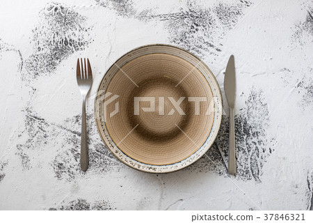 Plate on white wooden background with utensils Plate on white wooden background with utensils 37846321