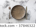 Plate on white wooden background with utensils 37846322