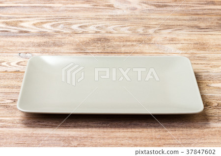 Blank rectangular plate on wooden background. 37847602