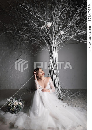 A young blonde bride in white wedding dress on a A young blonde bride in white wedding dress on a 37847689