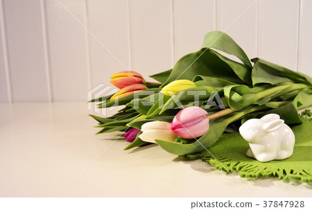 Easter concept, spring tulips and porcelain bunny Easter concept, spring tulips and porcelain bunny 37847928
