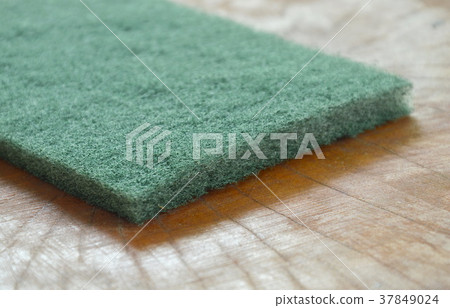 green scrub sponge for clean up on wooden board 37849024