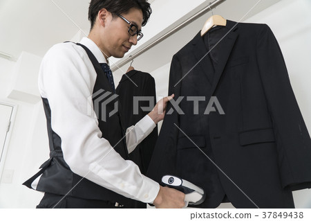 Businessman who irons suit 37849438