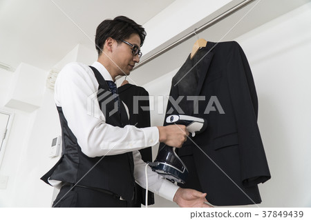 Businessman who irons suit Businessman who irons suit 37849439
