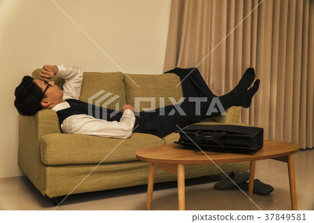 Businessman sleeping on the sofa tired of work Businessman sleeping on the sofa tired of work 37849581