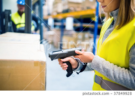 Warehouse woman worker with barcode scanner. 37849928