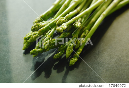 fresh green asparagus raw food on black counter 37849972