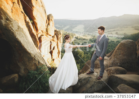 Young newly wed couple, bride and groom kissing Young newly wed couple, bride and groom kissing 37853147