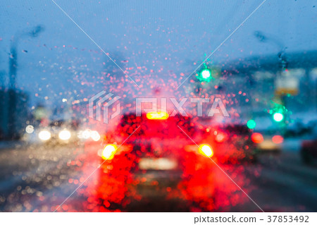 view through melting snow on car windshield 37853492