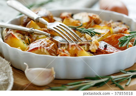 Potatoes baked with bacon and rosemary. Potatoes baked with bacon and rosemary. 37855018