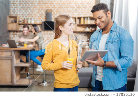 Joyful student holding her juice and a young man Joyful student holding her juice and a young man 37856130