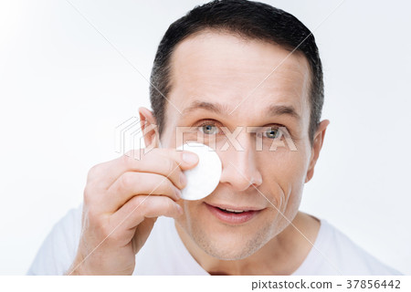 Portrait of a nice handsome man holding a cotton Portrait of a nice handsome man holding a cotton 37856442