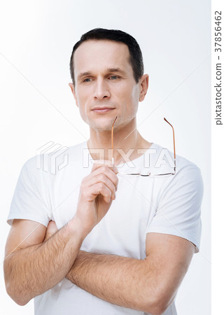 Handsome thoughtful man holding his glasses 37856462