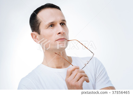 Serious smart man looking for a solution to a 37856465