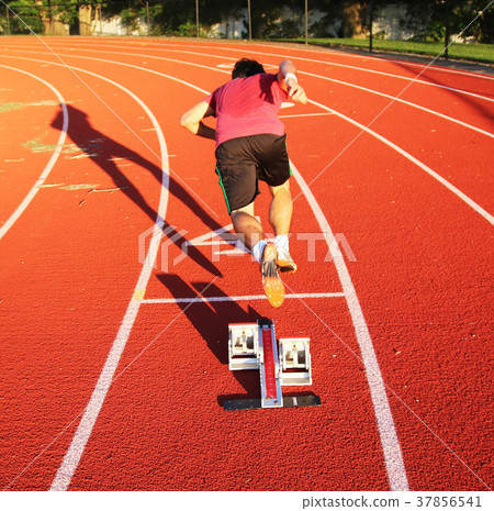 Athlete exploding out of starting blocks Athlete exploding out of starting blocks 37856541