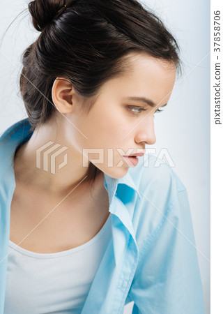 Reflective nice woman avoiding straight look 37858706