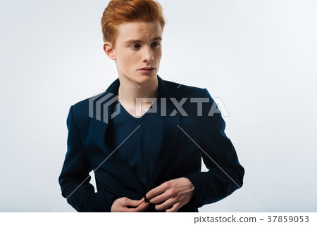 Stern man buttoning his jacket up 37859053