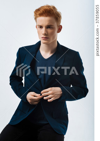 Meditative man buttoning his jacket up 37859055