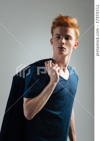 Stylish young red-haired man staring 37859312