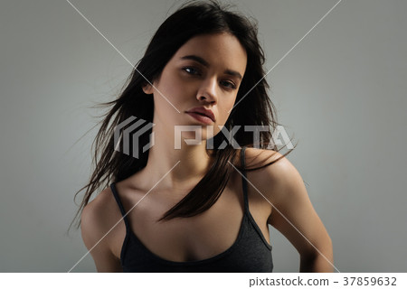 Pretty stern young woman staring Pretty stern young woman staring 37859632