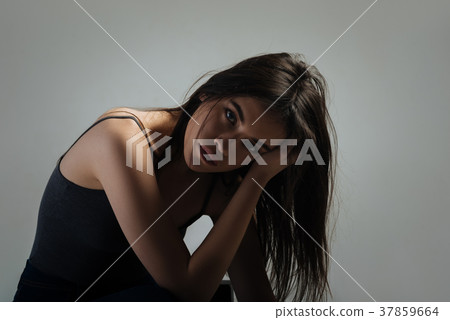 Sad woman sitting and thinking 37859664