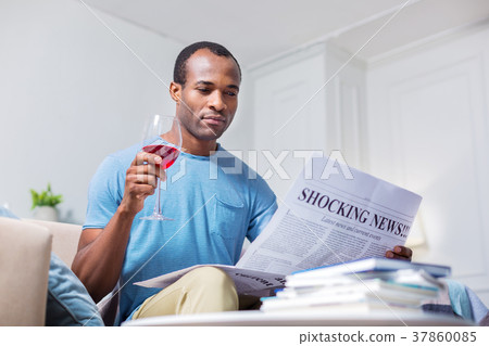 Pleasant nice man reading shocking news Pleasant nice man reading shocking news 37860085
