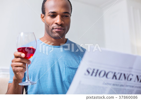 Positive joyful man reading articles Positive joyful man reading articles 37860086