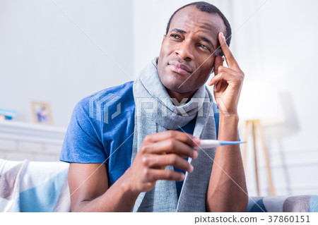 Serious thoughtful man touching his temple Serious thoughtful man touching his temple 37860151