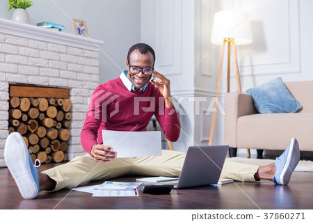 Positive hard working man making a call Positive hard working man making a call 37860271