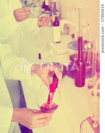 Hands working in chemical laboratory checking wine qualities 37860819