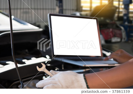 Mechanic repairing a car in garage Auto repair Mechanic repairing a car in garage Auto repair 37861339