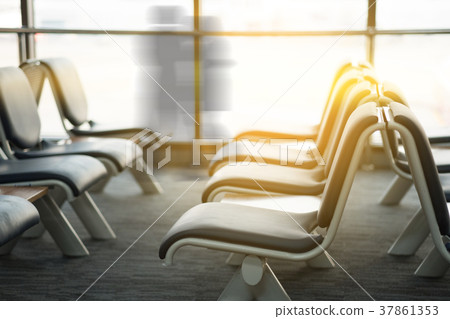 Empty airport terminal waiting area with chairs Empty airport terminal waiting area with chairs 37861353