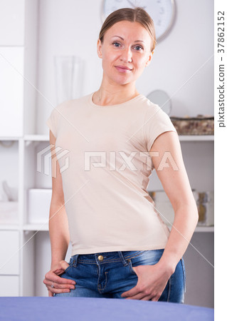 Woman standing with hand in pocket Woman standing with hand in pocket 37862152