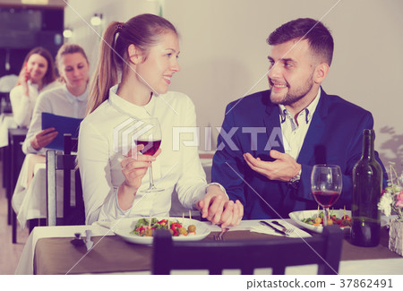 Elegant female and her boyfriend are celebrating date for dinner Elegant female and her boyfriend are celebrating date for dinner 37862491