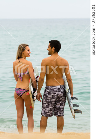 Young surfers couple on the beach 37862501