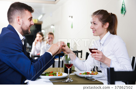 Elegant female and her boyfriend are celebrating date for dinner 37862502