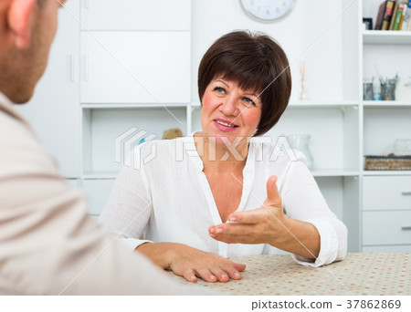 Employer discusses with elderly woman Employer discusses with elderly woman 37862869