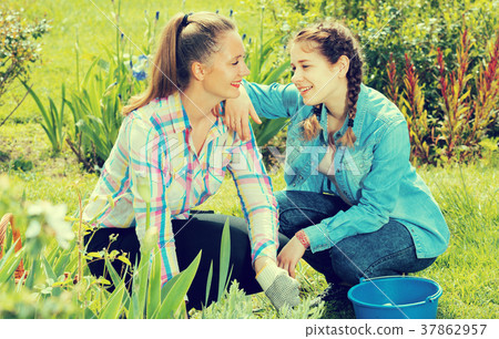 positive two young females working in the outdoor 37862957