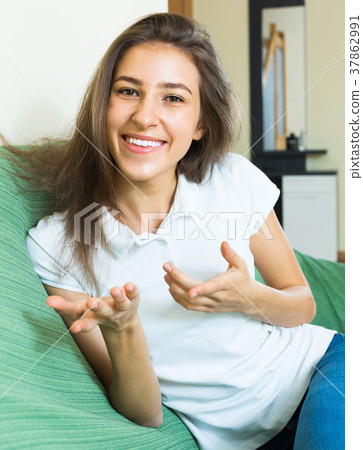 Smiling teenager girl on the couch Smiling teenager girl on the couch 37862991