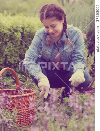 positive young female with shovel working in the outdoor 37863003