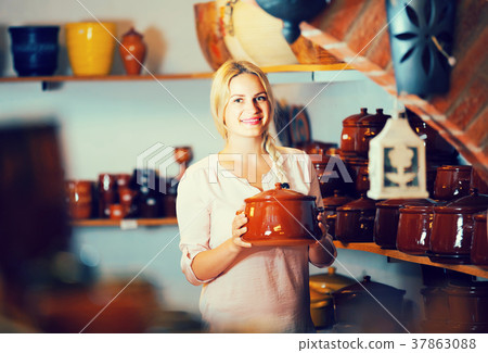 young woman selecting ceramic dish ware in atelier young woman selecting ceramic dish ware in atelier 37863088