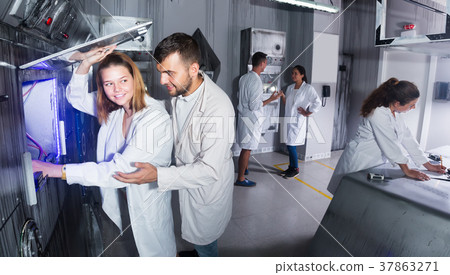 friends are searching for a solution in a quest room lab 37863271