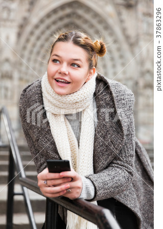 girl using mobile phone in scarf 37863296