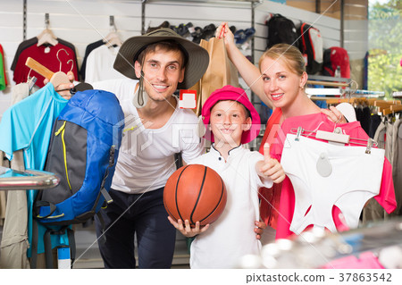 Young parents with boy shopping hiking goods Young parents with boy shopping hiking goods 37863542